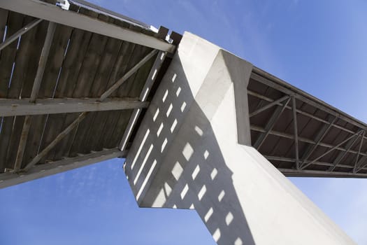 Photo taken under a bridge against clear blue skies.