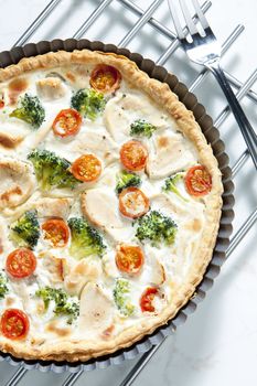 cake with broccoli, cherry tomatoes and chicken meat