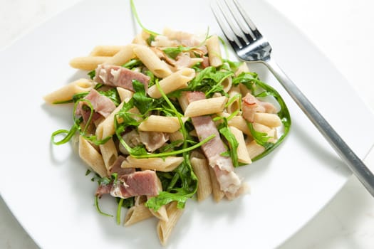 penne pasta with Parma ham and ruccola