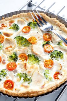 cake with broccoli, cherry tomatoes and chicken meat