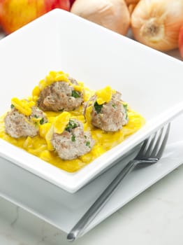 minced meat and herbs balls in apple and curry sauce