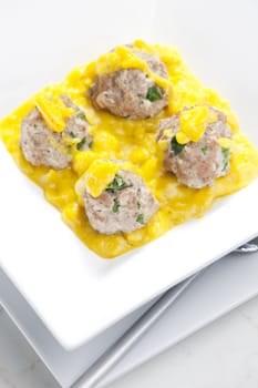 minced meat and herbs balls in apple and curry sauce