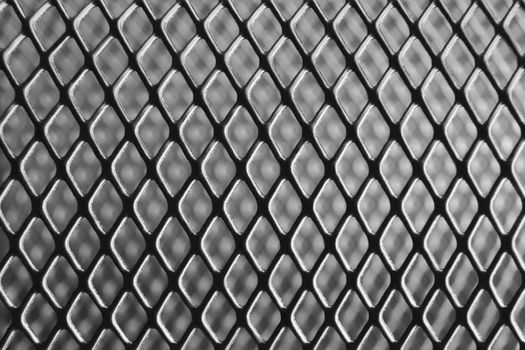 Macro photograph of a pen holder made of iron net.