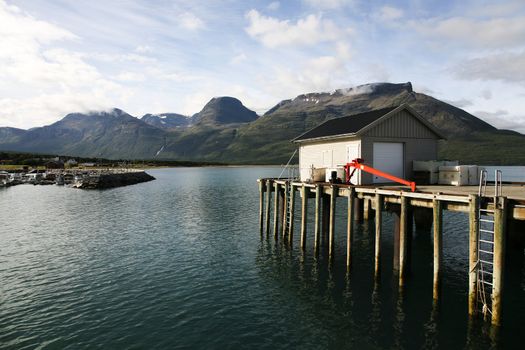 Norwegian mountains seen from a small harbor.