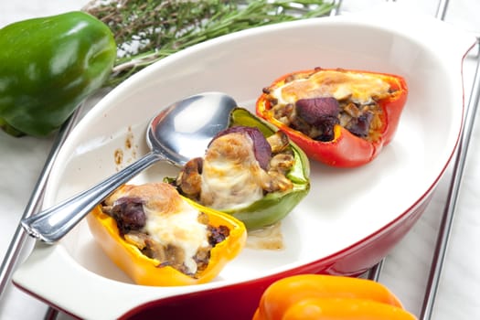 peppers filled with champignons and chicken livres baked with mozzarella cheese
