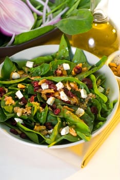 plate of fresh colorfull spinach salad close up