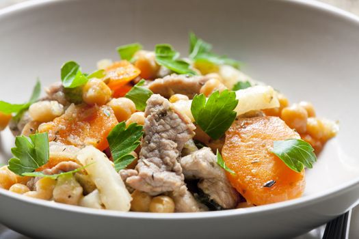 pork meat on celery with carrot and chick peas
