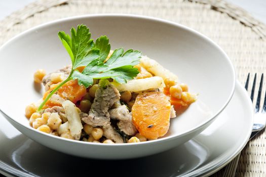pork meat on celery with carrot and chick peas