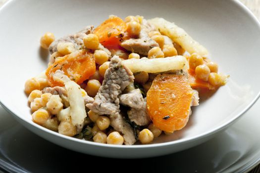 pork meat on celery with carrot and chick peas
