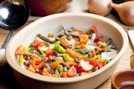 beef meat with peppers, onion and capers