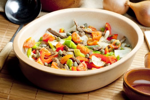 beef meat with peppers, onion and capers