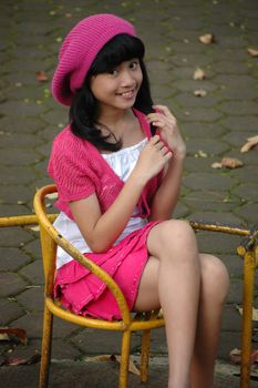 cute asian girl sit down in park