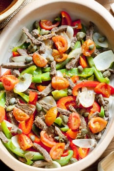 beef meat with peppers, onion and capers