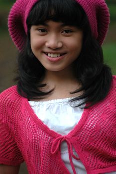 cute asian girl wearing pink hat