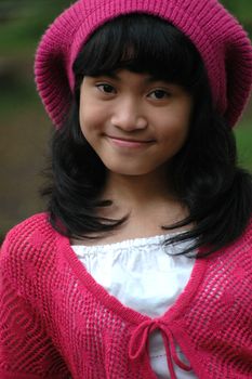 cute asian girl wearing pink hat