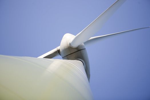Modern windmill producing renewable energy ecologically.