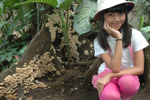 little asian girl sit down in park