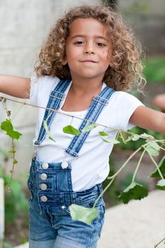 Cute little girl weeding the garden