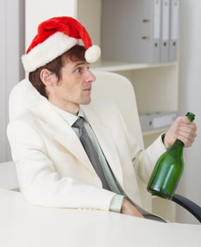 The young drunkard celebrates new year with a wine bottle