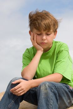 A child sitting and thinking.