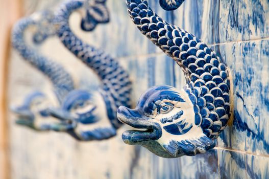 Close up of stone fountain with a fishes