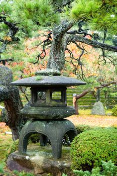 Granite lantern in the middle of wild garden