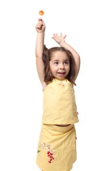 Playful girl holding a sweet lollipop candy on a stick