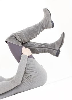 detail of lying woman wearing fashionable gray boots