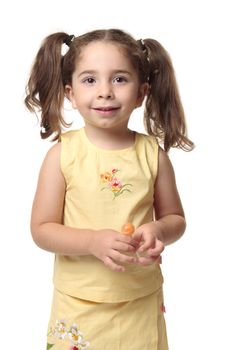 Pretty young toddler girl holding a sweet lollipop and smiling.