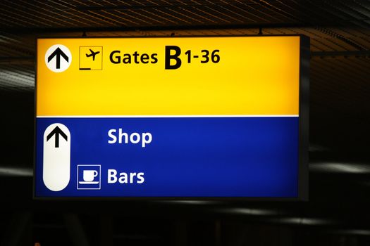 Airport information sign with directions to shops and gates