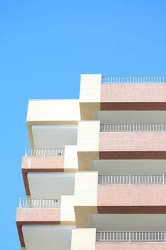 Detail of an apartment building and a clear blue sky