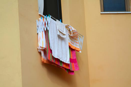 A laundry rack, hanging out of the window