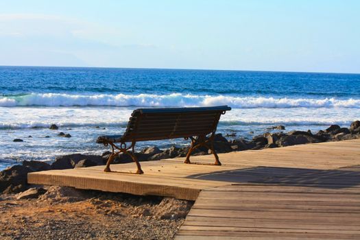 A wooden sofa on the boulevard, facing towards the Atlantic