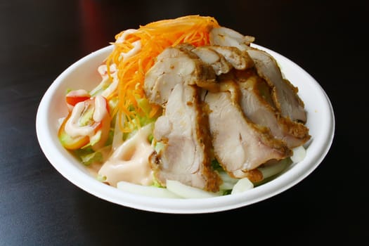 Salad With Chicken Slices on a Black Texture Table