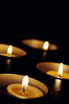 vertical background with four lit candles