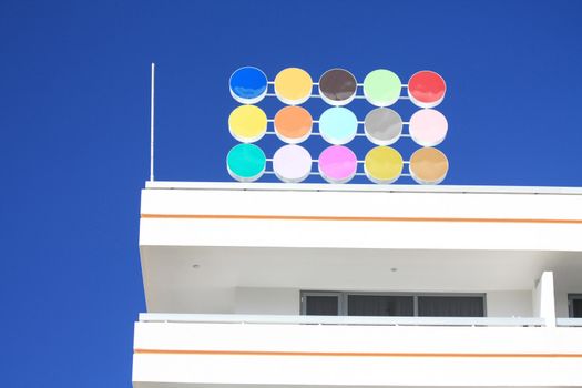 Abstract colored dots against a clear blue sky
