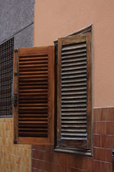 vintage window with shutters in colorful wall
