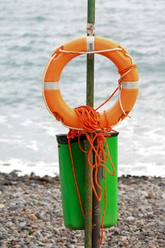 An orange life preserver and rope for first help