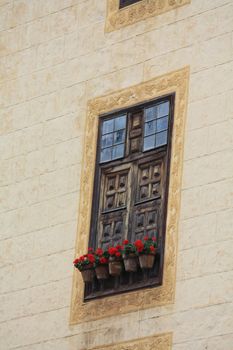 vintage window withwooden shutters and flower pots