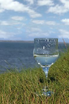 single glass of pure natural water standing on the beach in kerry ireland