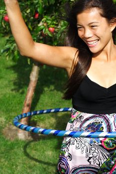  Hula hoop. Very beautiful young woman doing hula hoop outdoors in the fall. 