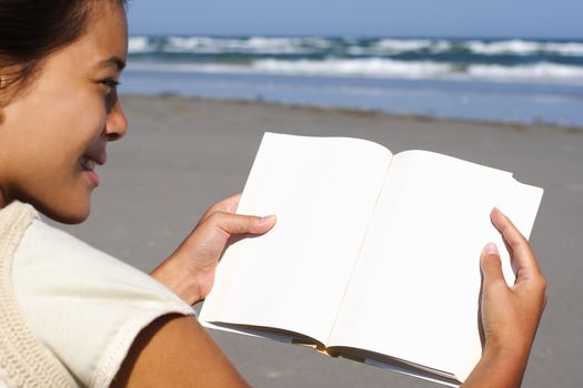 reading woman of book with blank copyspace on the beach.