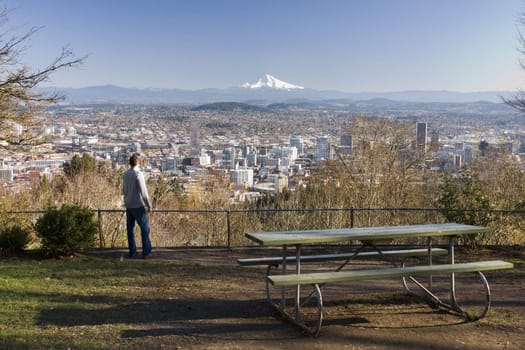 Male model overlooking city of Portland, Oregon.