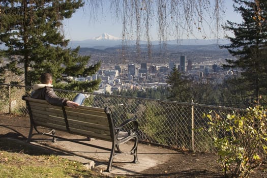 Male model overlooking city of Portland, Oregon.