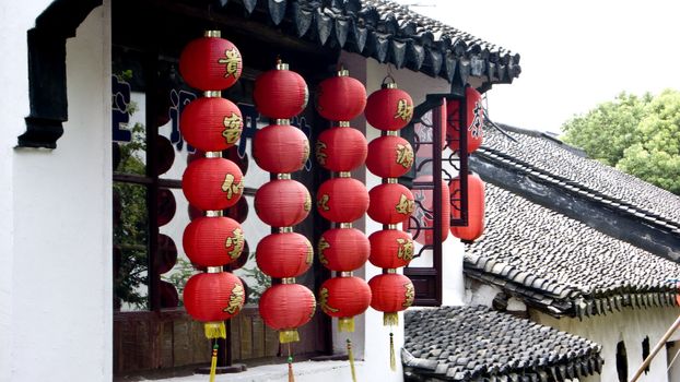 Red lanterns hanging from the ancient architecture
