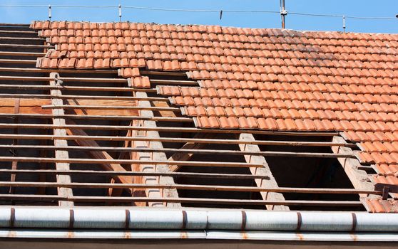 Roof renovation, removing tiles and exposed framework