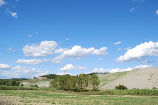 Topycal Tuscan landscape with hills, vineyards, cypresses during the autumn