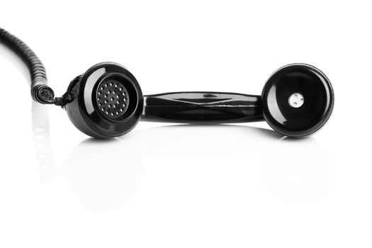 Telephone handset isolated over a white background, focus is on the handset