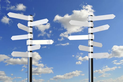 white direction signs on metal pole, against blue sky with white clouds