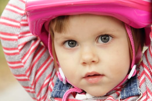 Cute little girl with a pink helmet